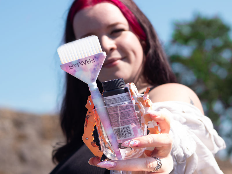 Woman holding a glass and a brush with 'Framar' branding. Canadian brand of hair tools and accessories. Sugarloaf Mountain-Hairstylist Reese Hobbs Nanaimo - Multinex Media-Photoshoot