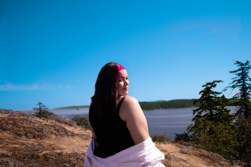 Canadian hairstylist-Reese Hobbs- standing on a hill overlooking a Departure Bay with trees and clear blue sky. Sugarloaf Mountain-Hairstylist Reese Hobbs Nanaimo - Multinex Media-Photoshoot